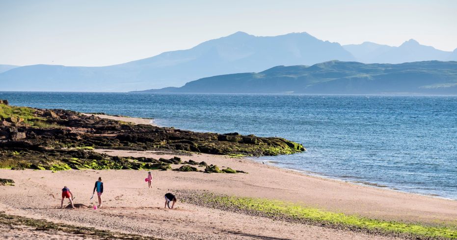 family walking along beach
