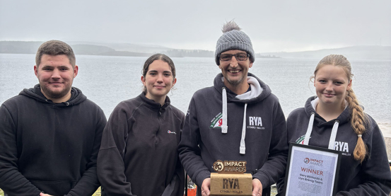 Training team representatives receiving their Impact Award at Llyn Brenig SC - left to right - Ryan Hill, Sophie Hill, Gary Richards (Chief Instructor) and Torie Richards. 