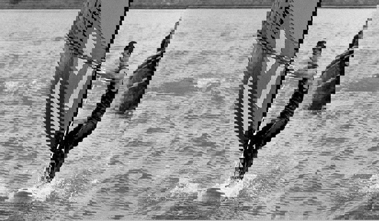 Black and white photo of windsurfing Prince Charles 