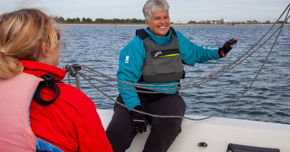 closeup of two women sailing a dinghy