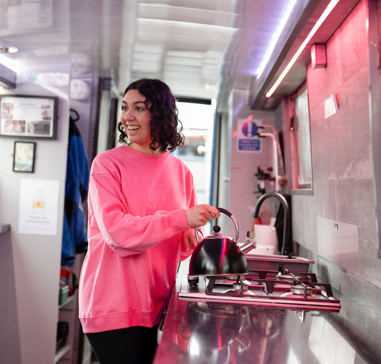 Mid shot of woman using gas appliance on boat