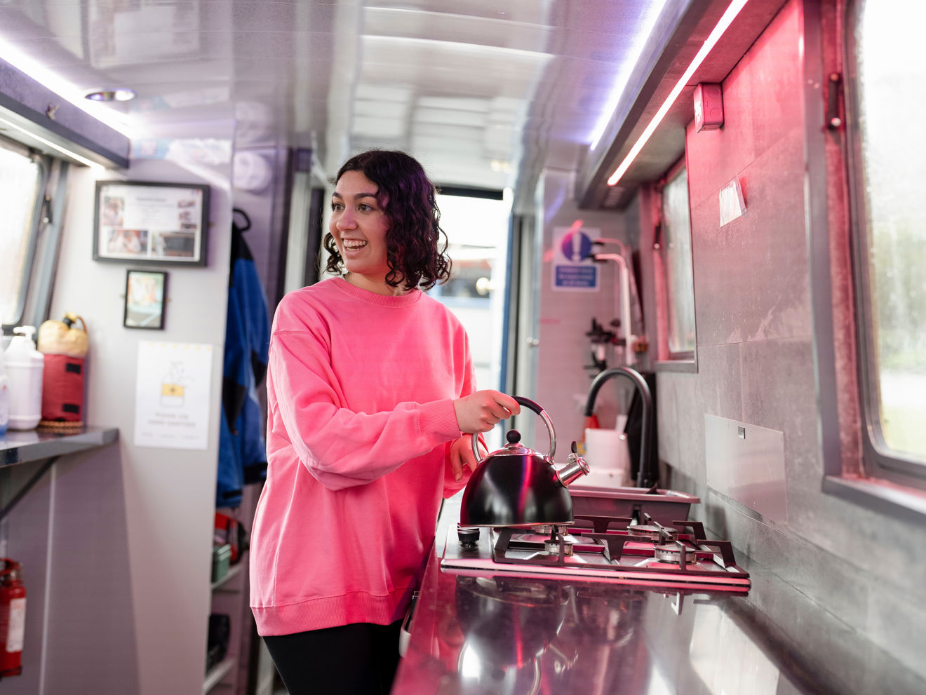 Mid shot of woman using gas appliance on boat