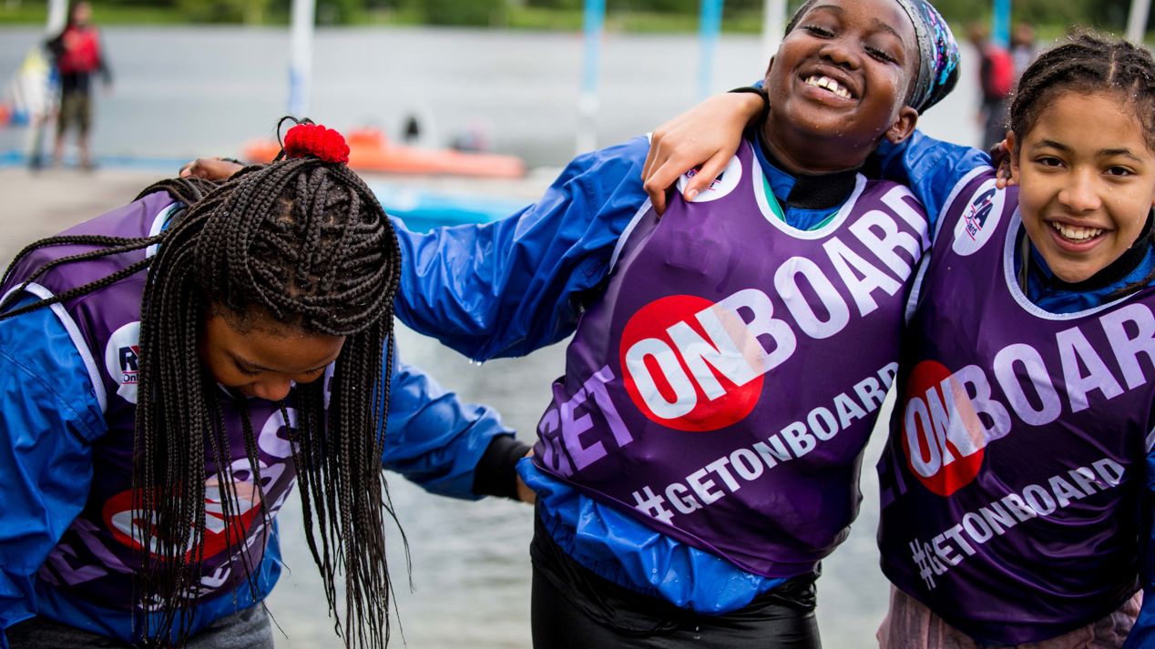 Children smiling and enjoying an onboard sailing session