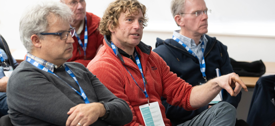 Midshot of attendees participating in a conference