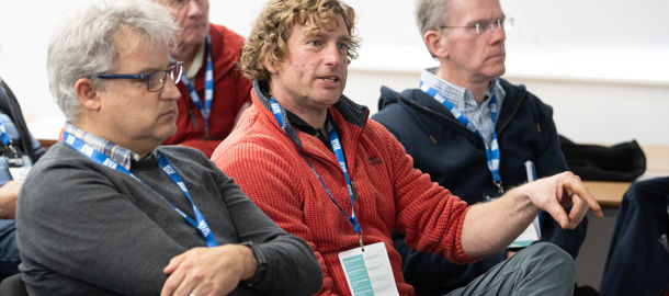 Midshot of attendees participating in a conference