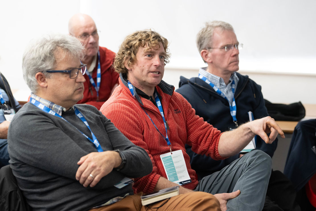 Midshot of attendees participating in a conference