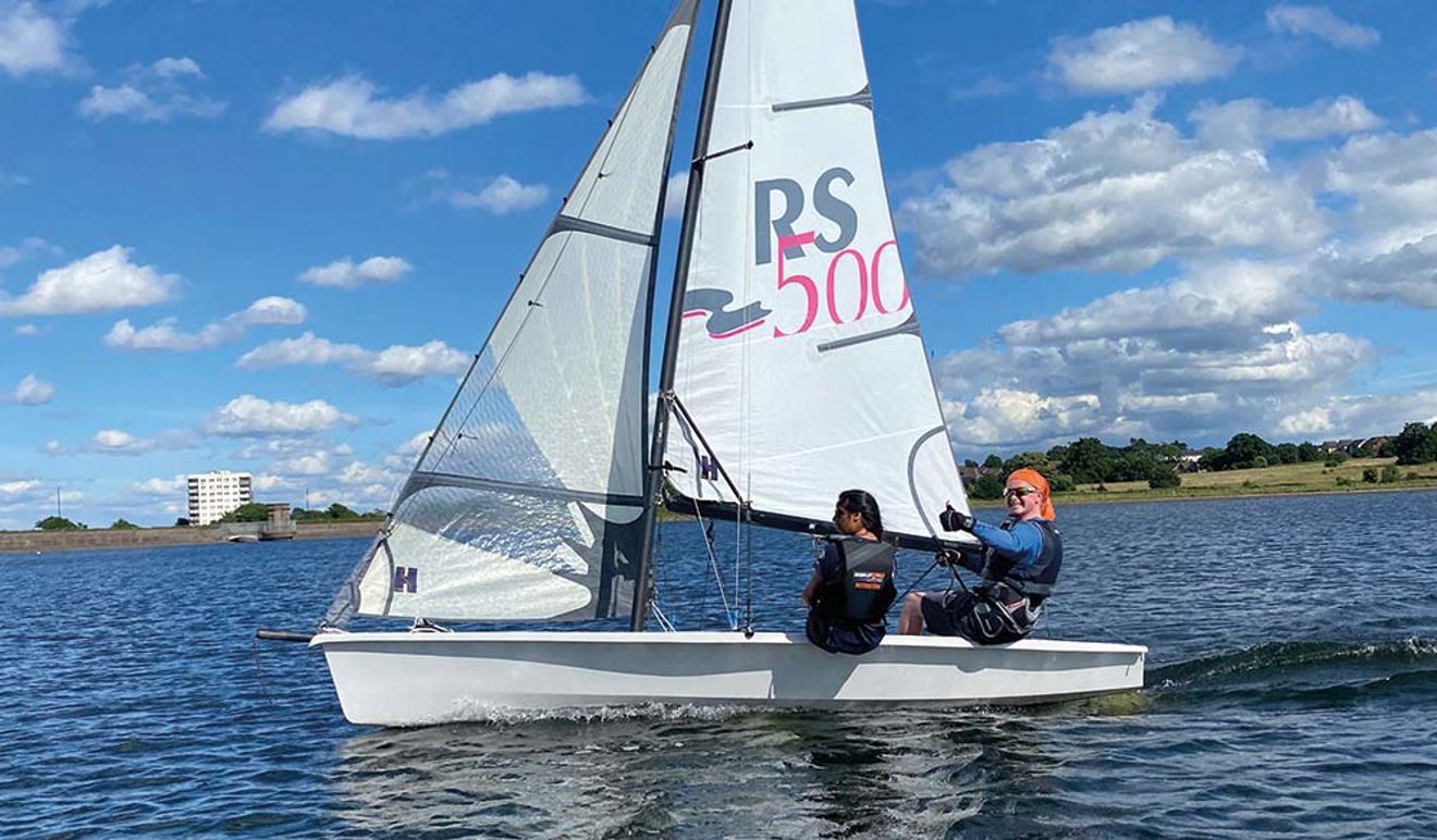 kids on a boat giving a thumbs up