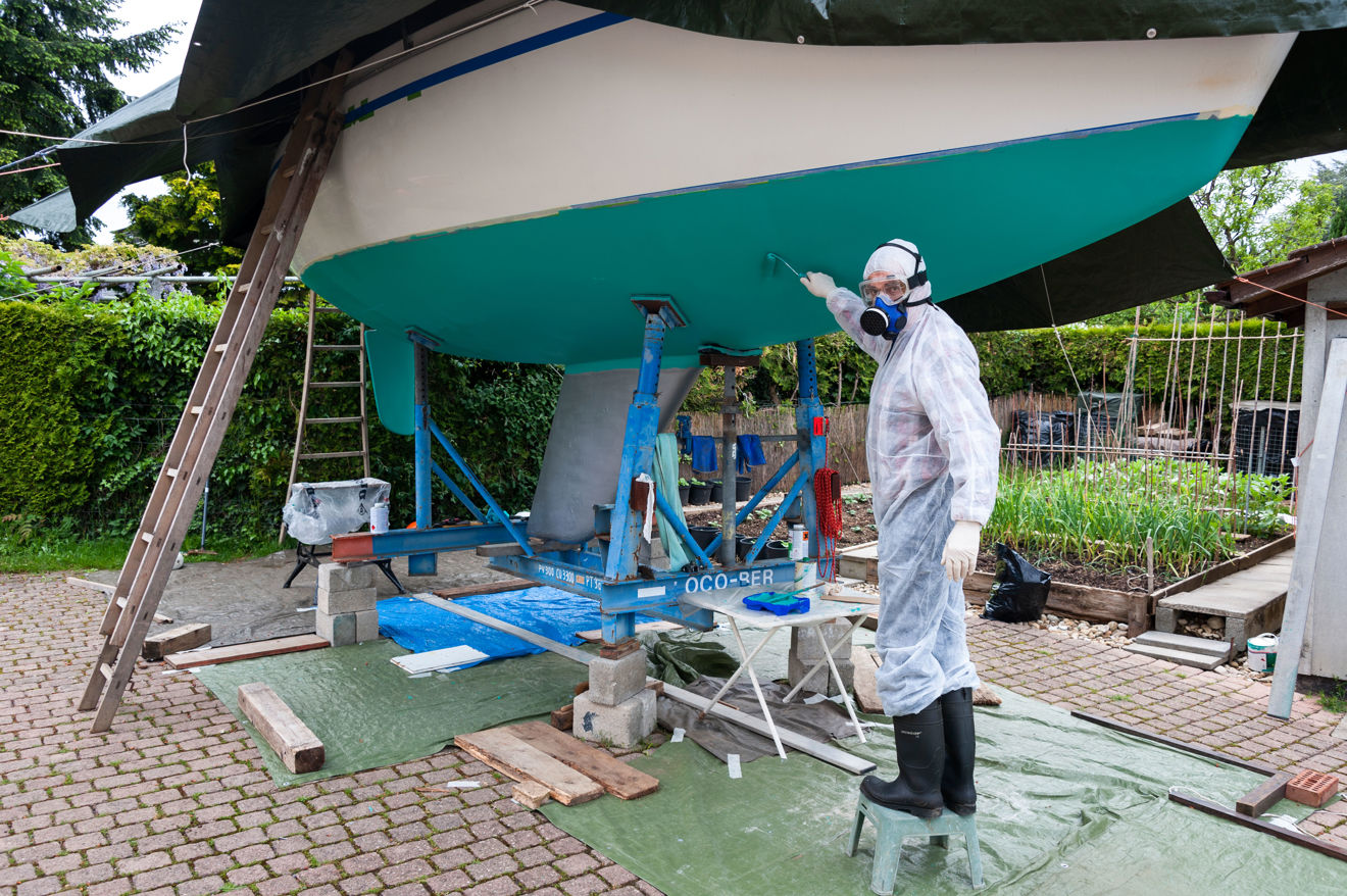 Shot of man using antifouling paint in an environmentally safe way