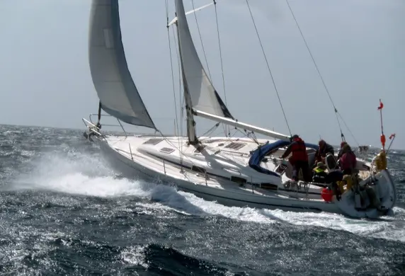 People on a yacht sailing on the open sea on a day skipper course