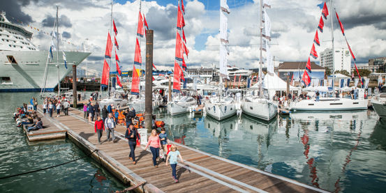 	An image of Visitors exploring and walking down by the boats in sea during the Southampton Boat Show