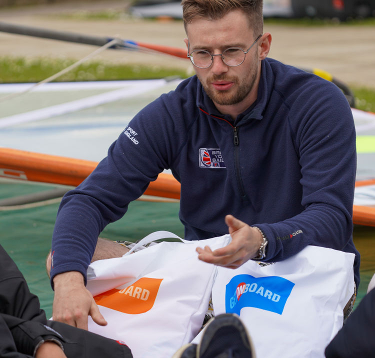 group of children sat listening to an instructor explaining something