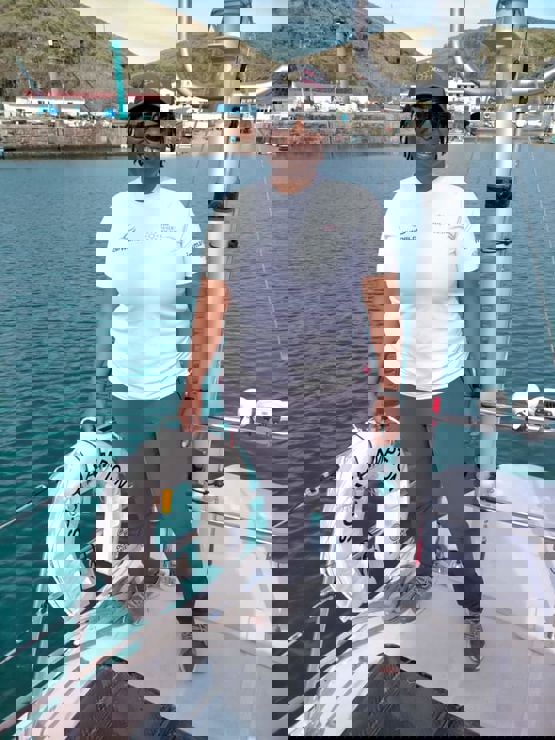 posed shot of woman standing on sailing yacht going into dock