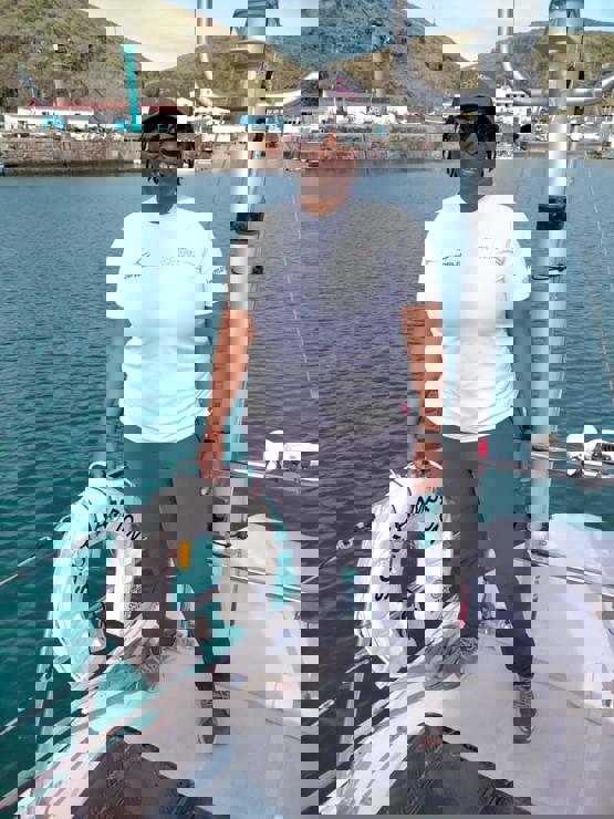 posed shot of woman standing on sailing yacht going into dock