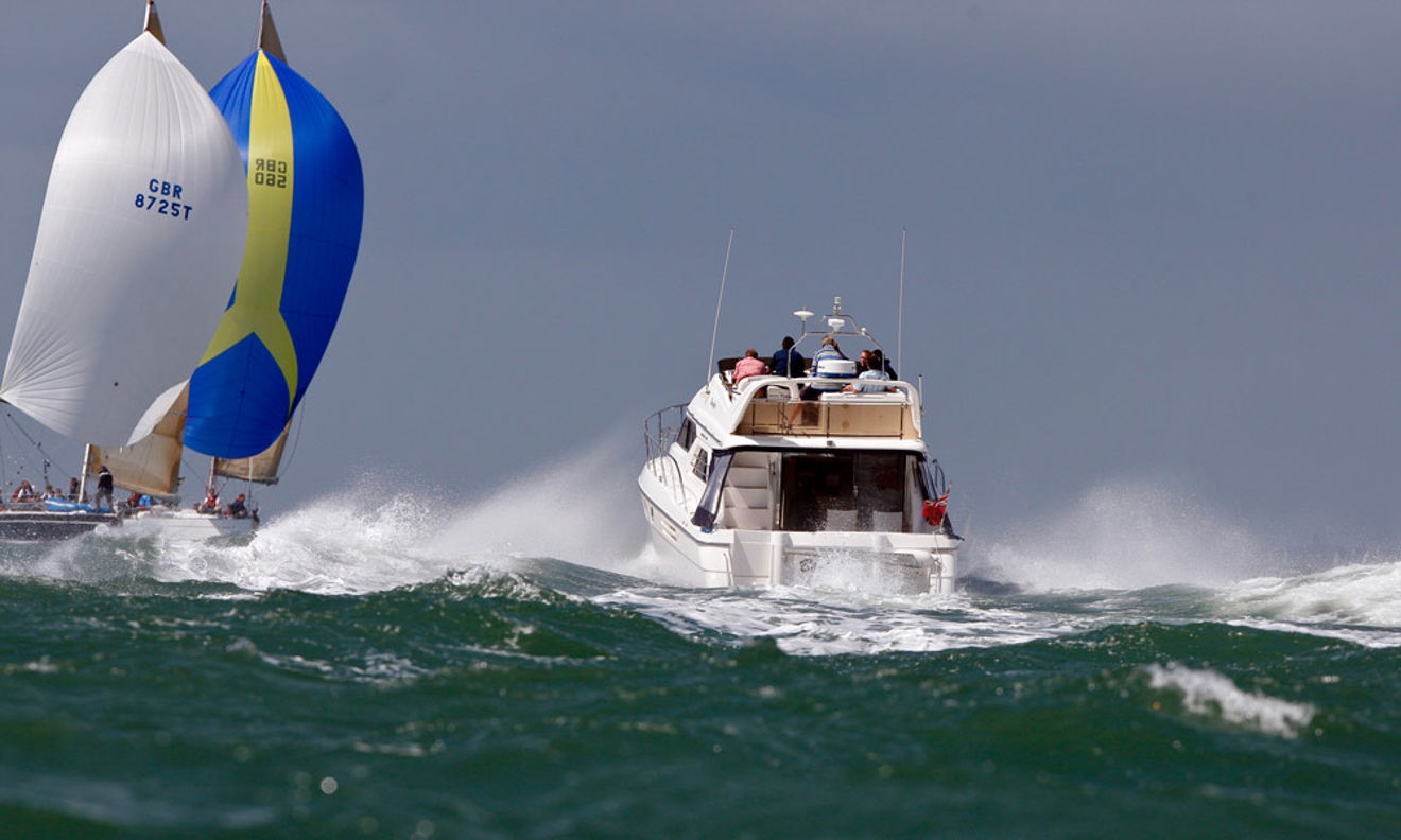 choppy ocean with motor cruiser and sailing yacht in the distance