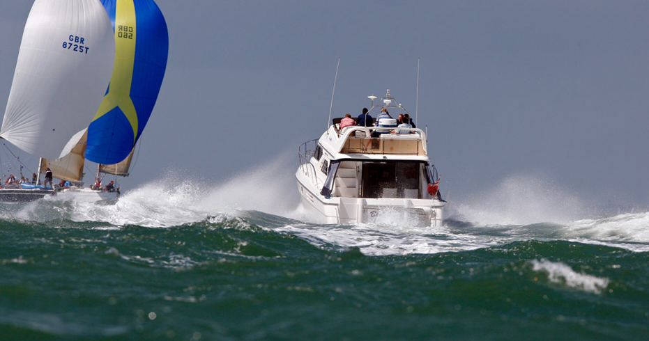 choppy ocean with motor cruiser and sailing yacht in the distance