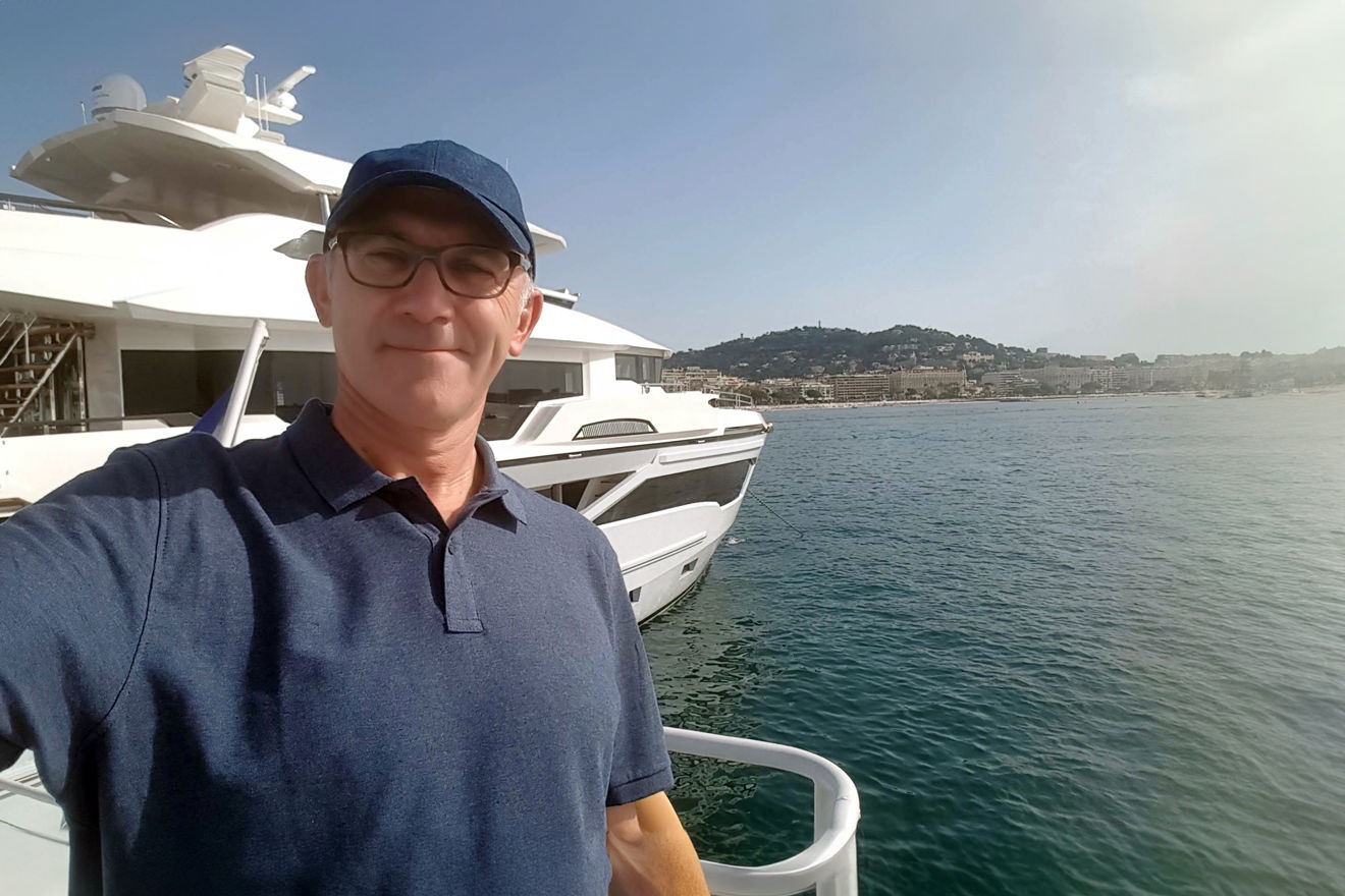 Selfie of Stephen stood on the dock in front of his boat