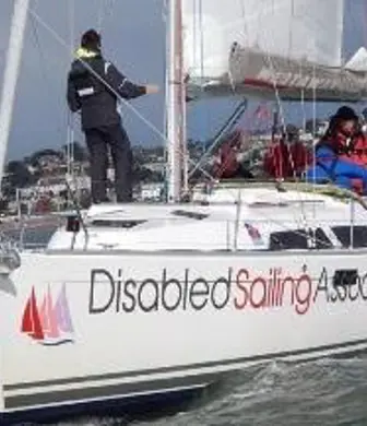 A group of people onboard a sailing yacht with the Disabled Sailing Association in Torquay, Devon