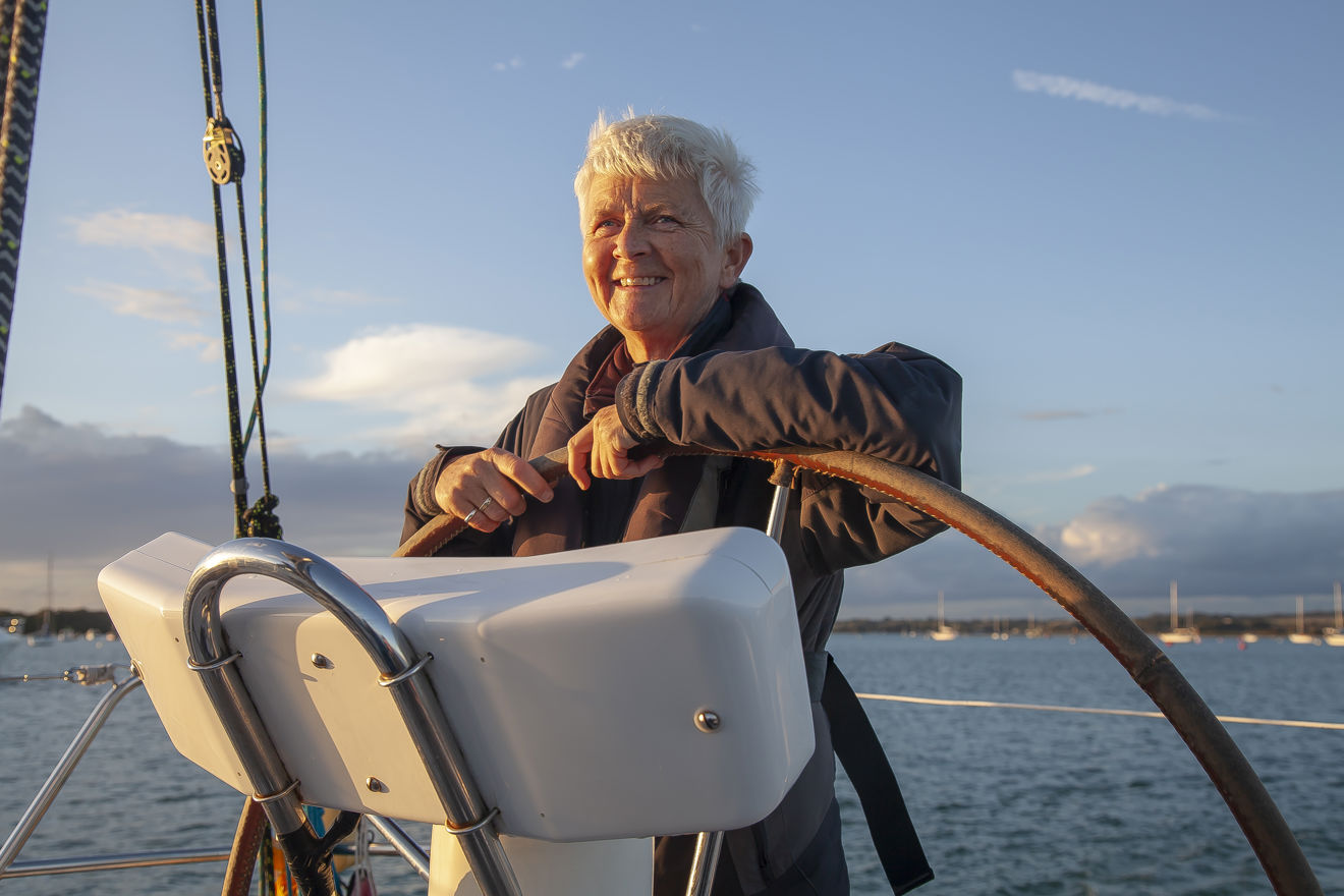 Lady At The Helm Of A Boat