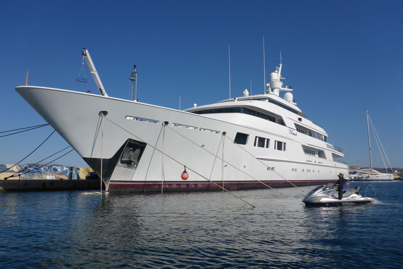 superyacht moored at marina on sunny day
