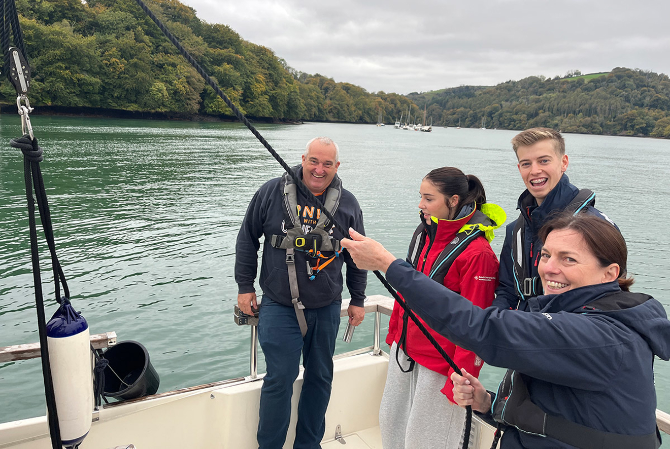 RYA CEO Sara Sutcliffe gets hand on crewing during a tour of South West clubs and training centres