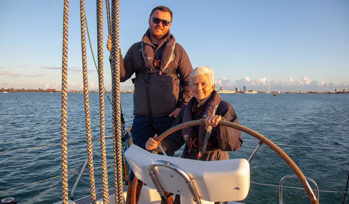 Two people on a boat at sunset 