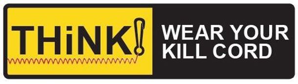 A safety sign with the text "THiNK! WEAR YOUR KILL CORD" in black and yellow.