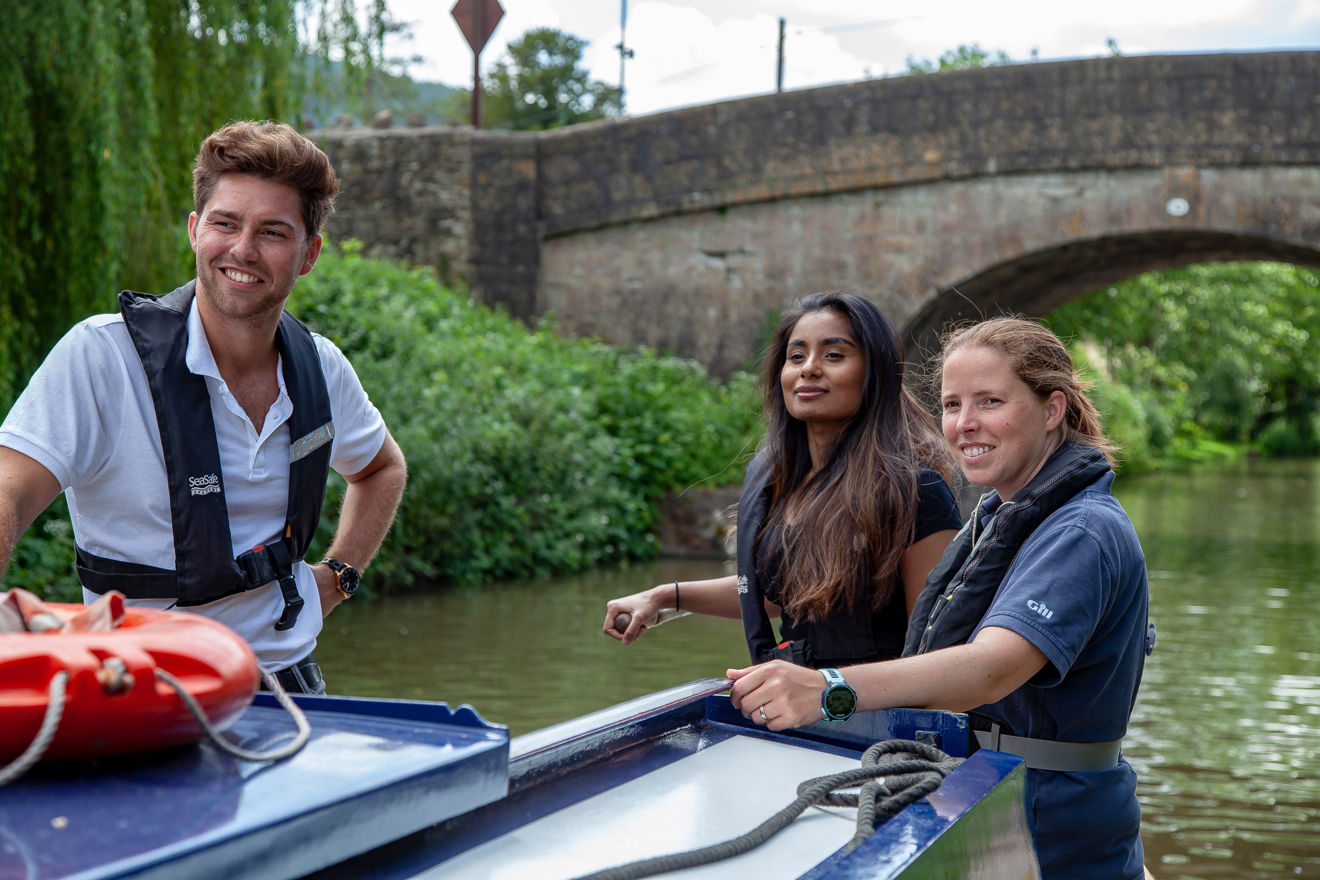 Man and two women on a canal boat on the inland waterways