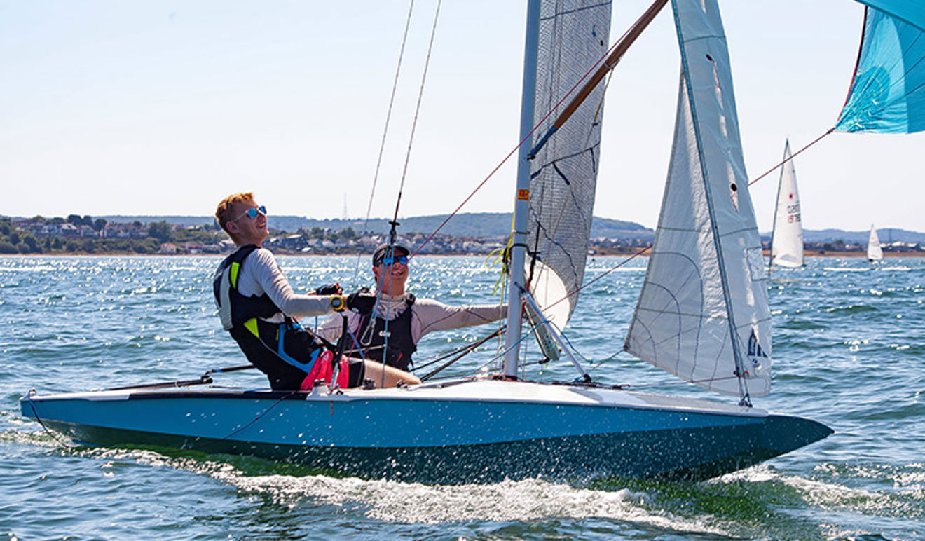 Two people enjoying sailing downwind