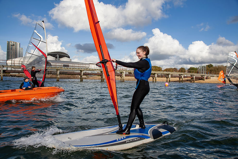 A girl trying windsurfing for the first time