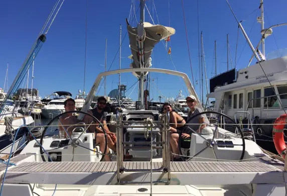 People sat relaxing on a Barcelona Watersports yacht moored in the marina