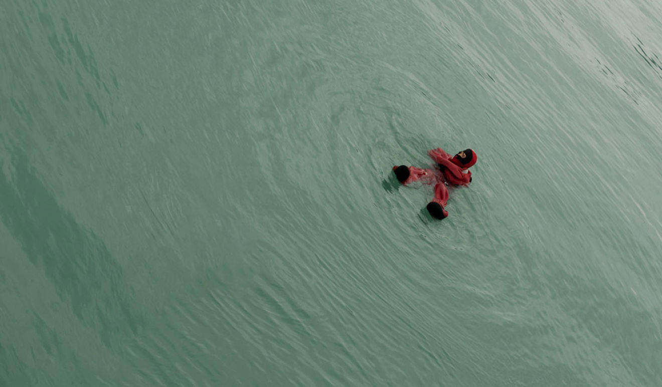 Man floating in water after falling from boat