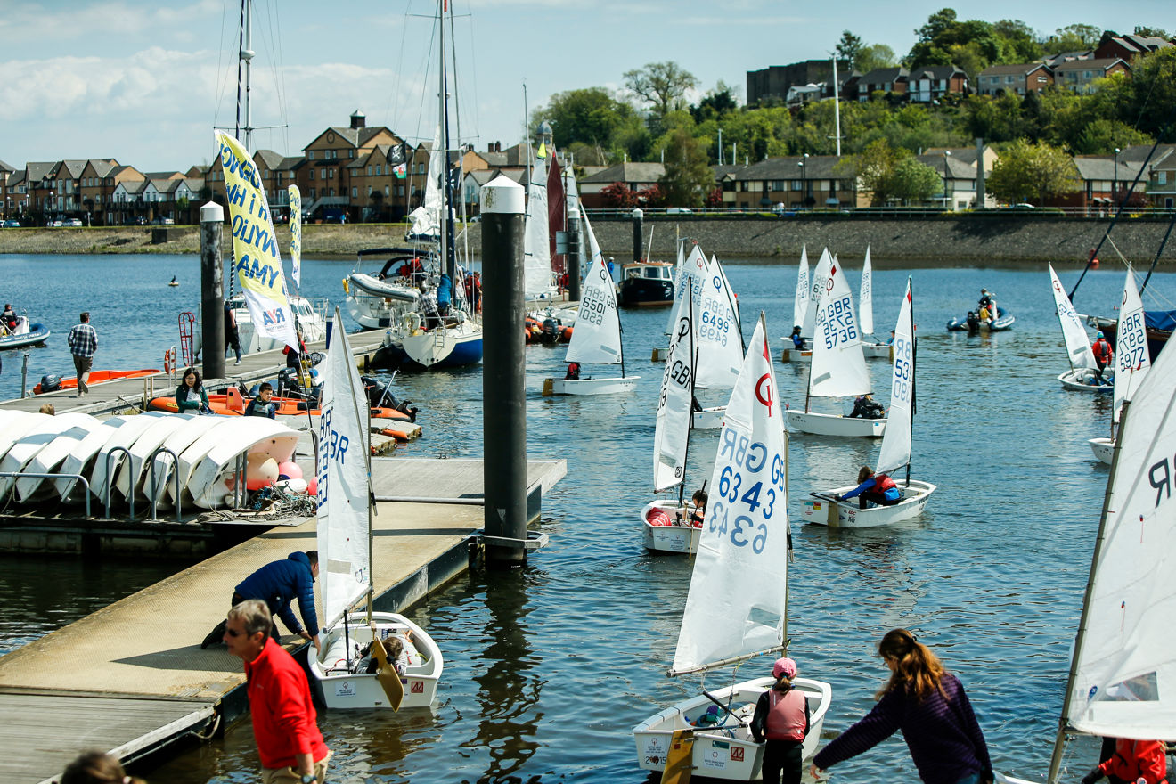Numerous dinghies setting off from the dock