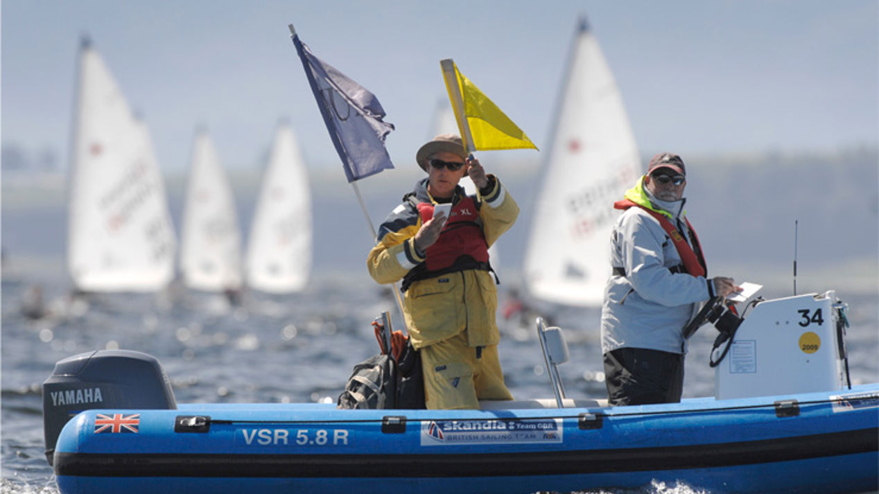 	2 race officials officiating a race..