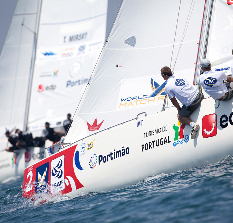 sailors sat on the edge of their boat