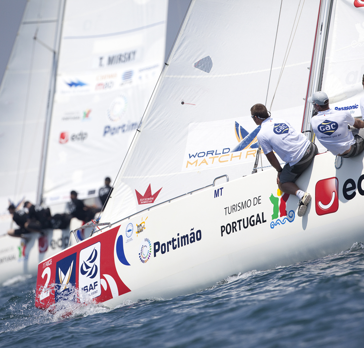 sailors sat on the edge of their boat
