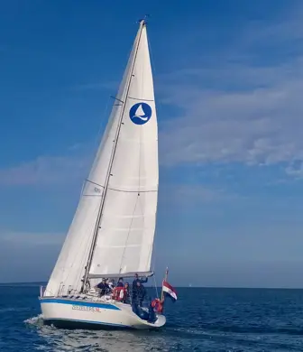 A yacht from Dutch Offshore Sailing Academy, Zeezeilers sailing on a calm sunny day