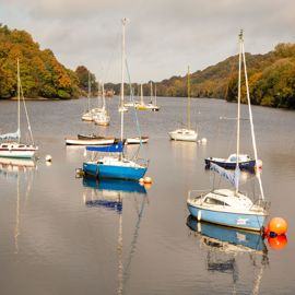wide shot of sailing boats moored on a river