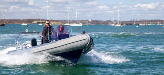 	An image of a couple sailing on a high speed boat