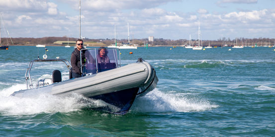 	An image of a couple sailing on a high speed boat