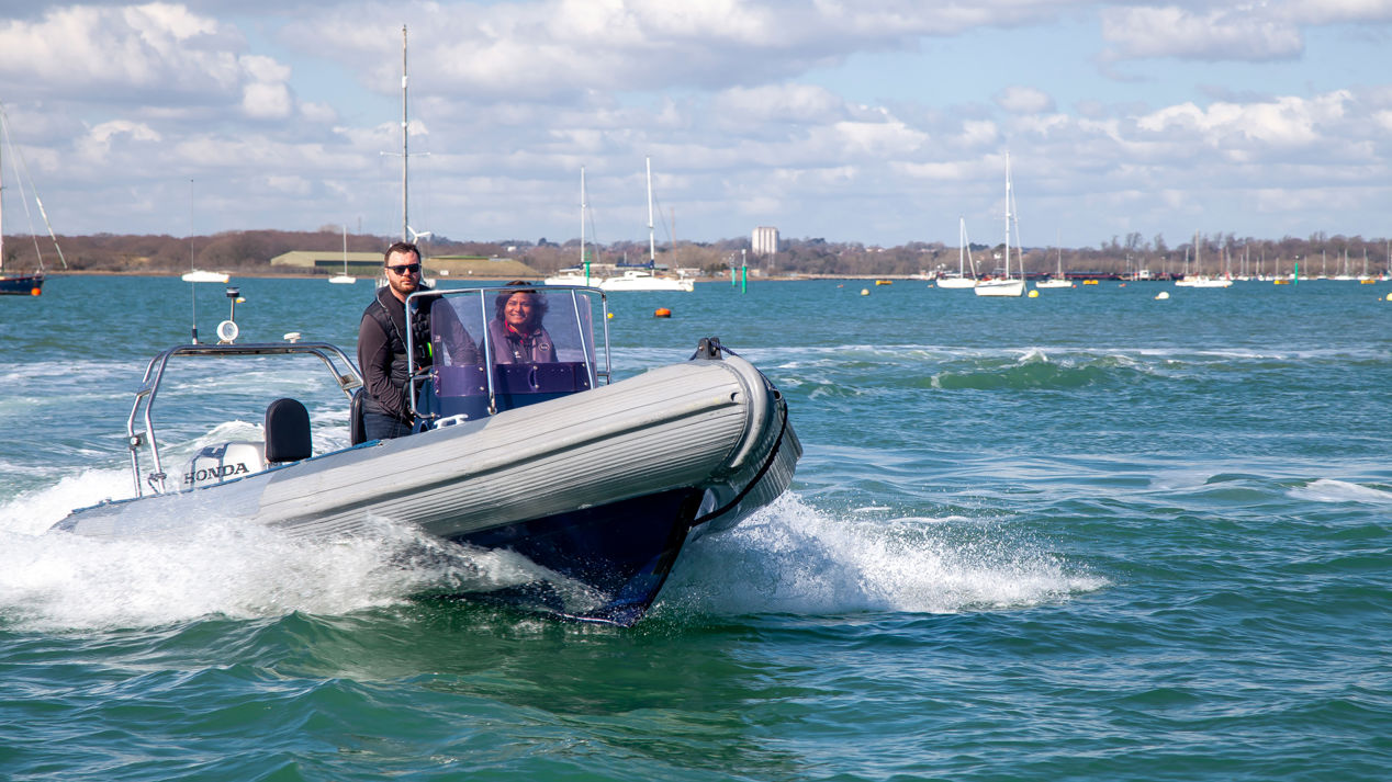 	An image of a couple sailing on a high speed boat
