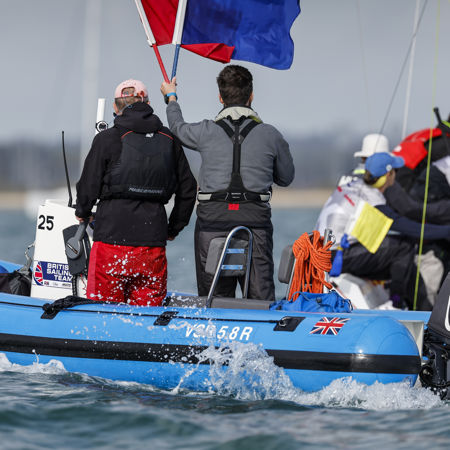 Race officials holding flags up to indicate race points