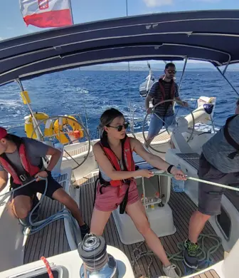 A group of people busy sailing a yacht on a lovely sunny day on the water with Yacht Sail Training School, Brac Island, Croatia