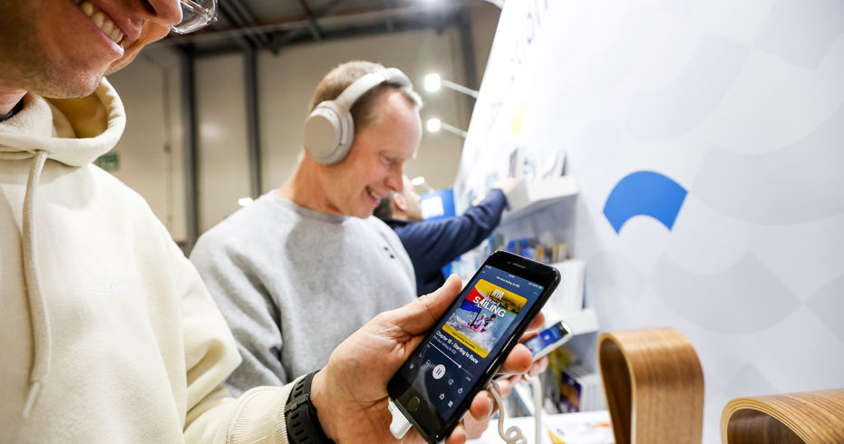 Mid shot of person using RYA shop on their mobile