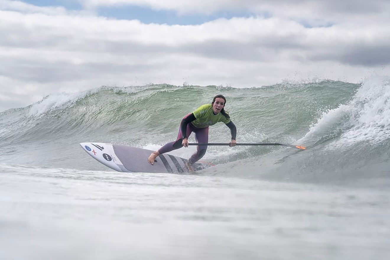An image of Holly Bassett by the wave in RYA Dinghy & Watersports Show 2024