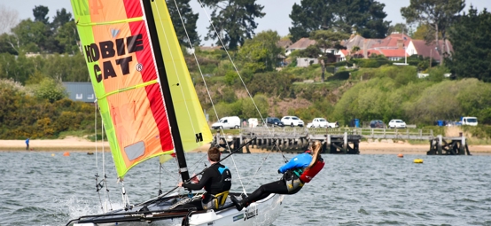 mid shot of sailors using a multihull on sunny day