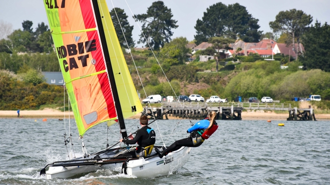 mid shot of sailors using a multihull on sunny day