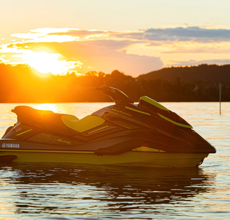 PWC jetski parked in front of sunset