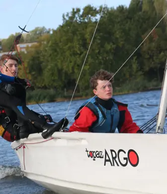 Three children sailing a Topaz Targo sailing boat