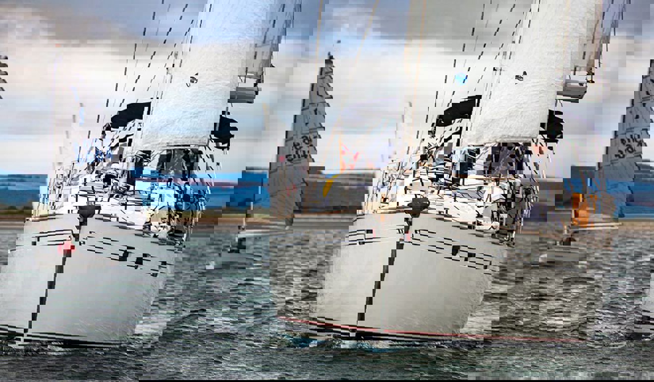 	mid shot yacht on the lake with dinghy in the background