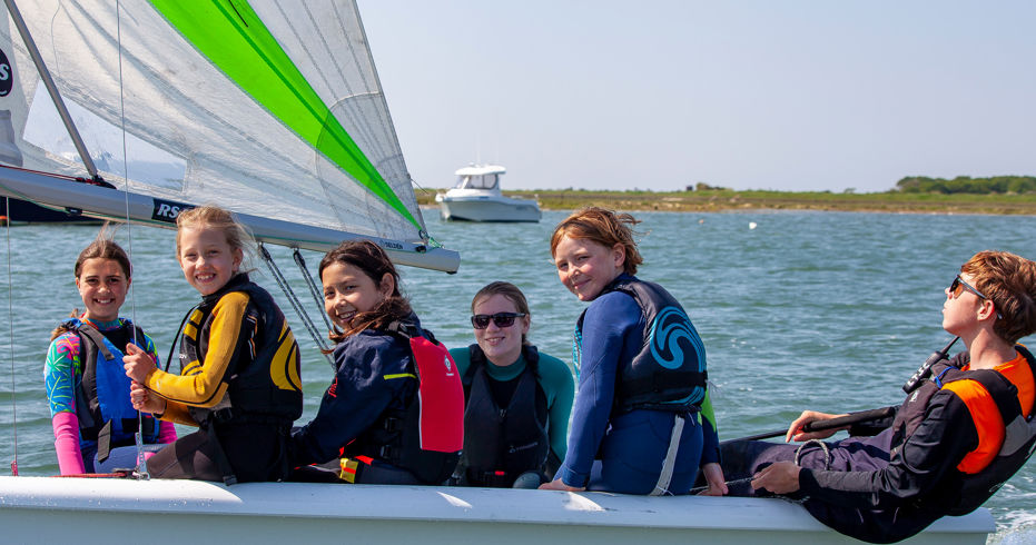 	a group of children in an RS quest sailing dinghy
